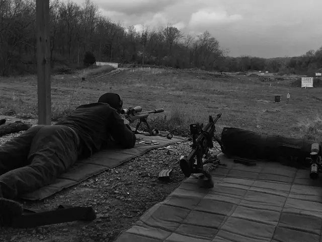 A student shooting a rifle from the prone position